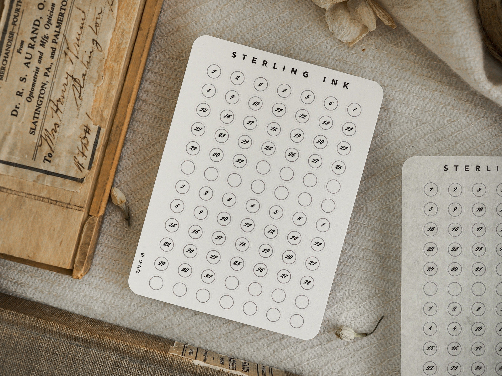 White sheet of circular calendar date stickers for December 2022, displaying numbered days 1 through 31 arranged in a clean, organized grid.
