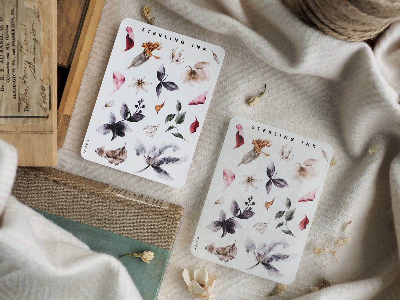 Botanical sticker sheet featuring delicate watercolor illustrations of dried leaves, autumnal petals, and small pods in muted sage, taupe, and dusty rose tones.