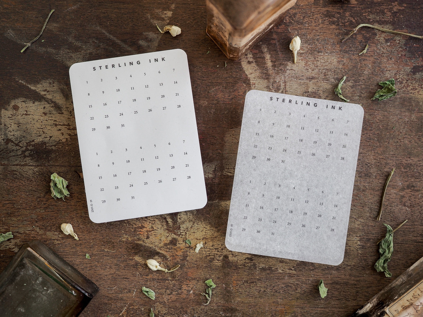 White monthly date stickers displaying a structured calendar grid for days 1 through 31, branded with "Sterling Ink," perfect for journaling and planners.