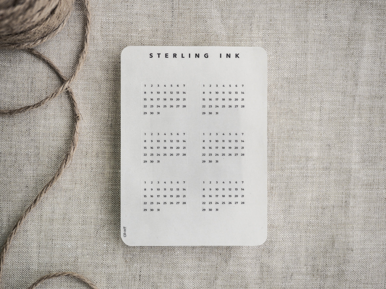 Monthly tracker card featuring a clean white background and a precise black calendar grid layout, branded with "STERLING INK" for easy date planning.