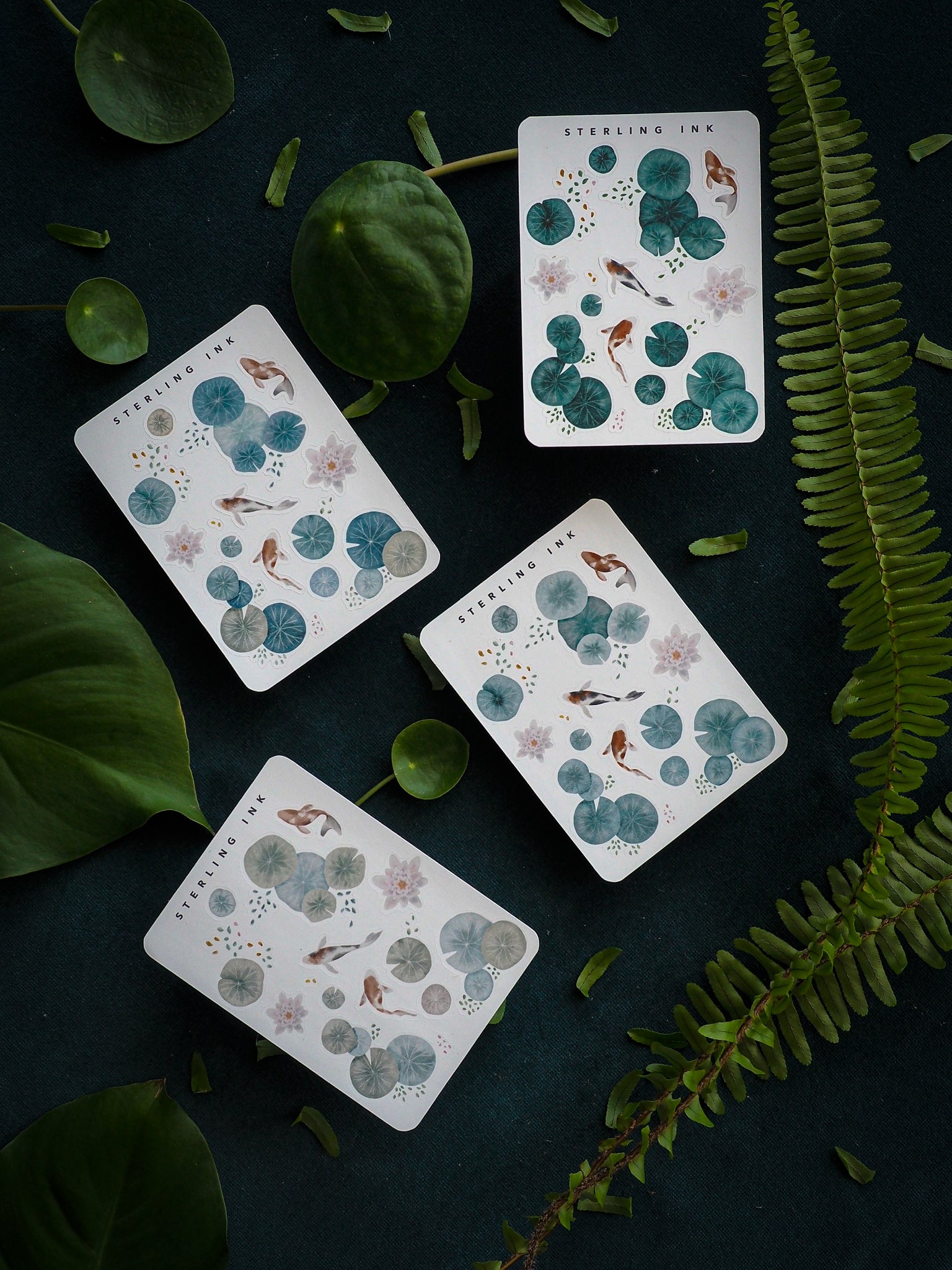 Botanical stickers featuring detailed illustrations of small birds, lush foliage, and assorted leaves in deep green, gray,