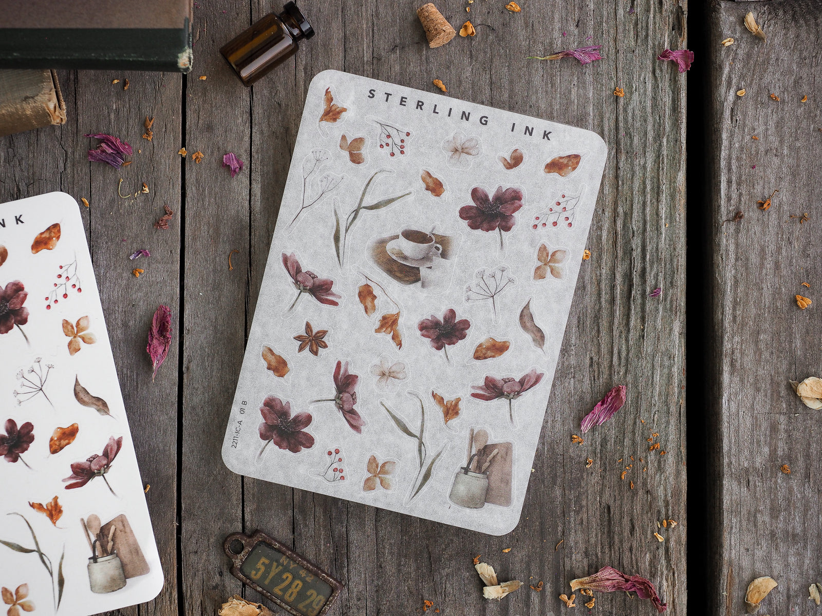 Decorative mini sticker sheets featuring delicate botanical elements, including autumnal leaves, dried florals, berries, and potted plants, arranged in a minimalist seasonal pattern.