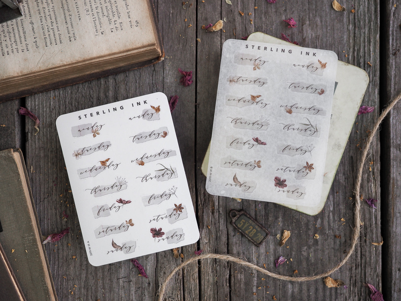 Delicate cream-colored sticker sheets featuring hand-lettered days of the week and elegant, rustic botanical leaf designs.
