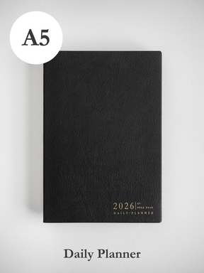 Sleek A5 black daily planner featuring metallic gold foil stamping that prominently displays "2026 Daily Planner" for organization.