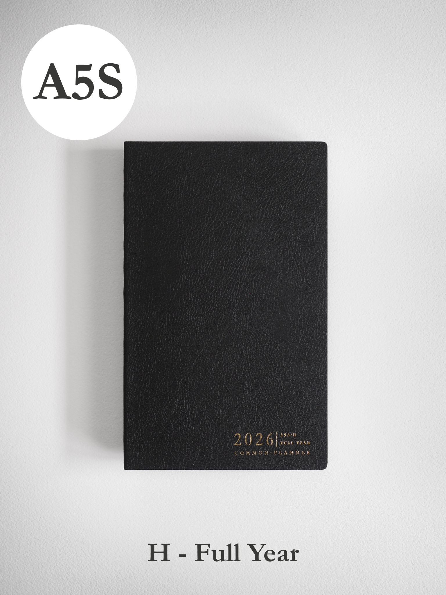 Minimalist black A5 slim planner cover for 2026, subtly embossed with the year and brand name in clean typography.