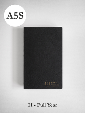 Minimalist black A5 slim planner cover for 2026, subtly embossed with the year and brand name in clean typography.