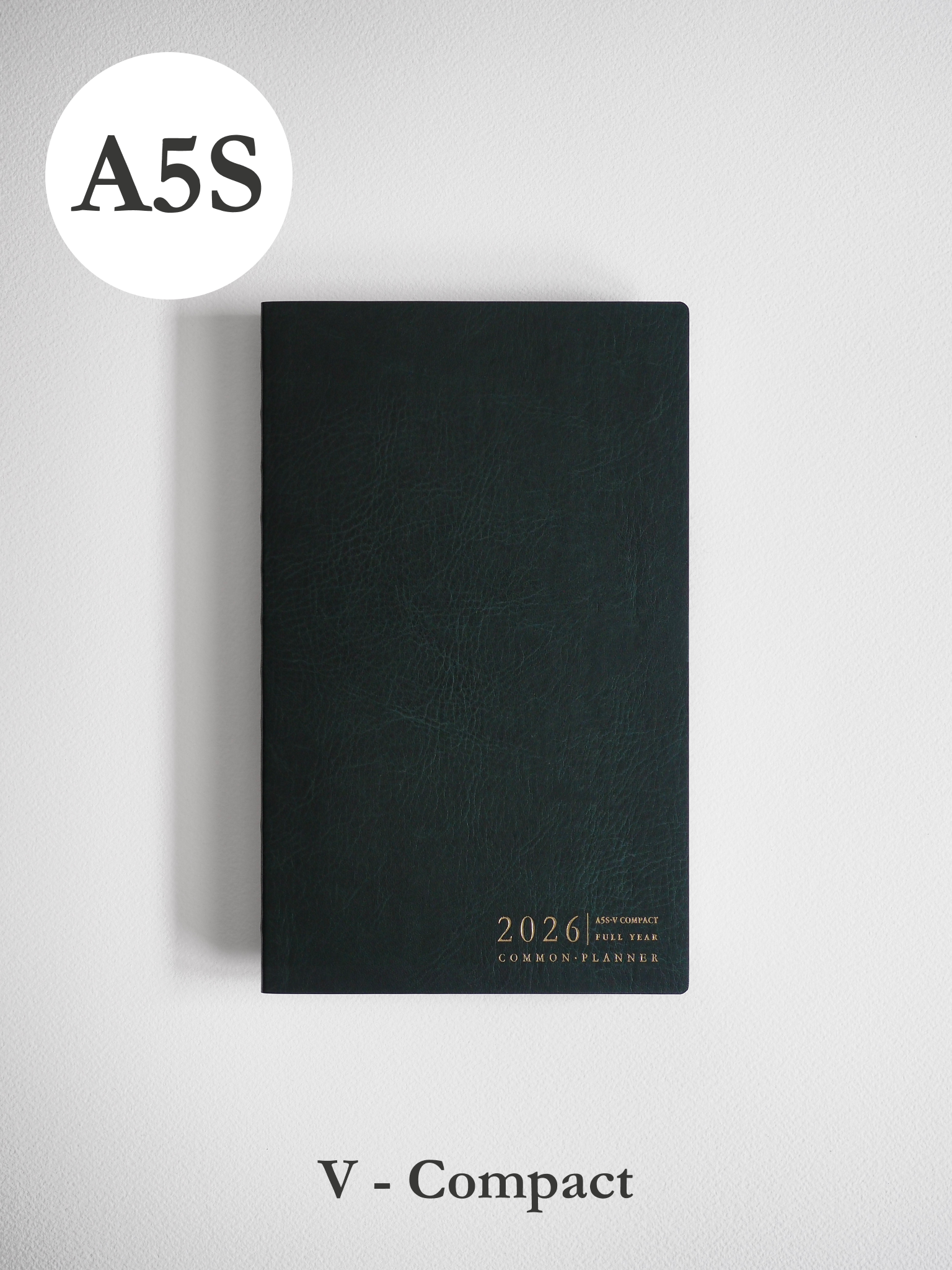 A minimalist, matte black vertical planner cover featuring elegant metallic typography centered at the bottom for the year 2026.