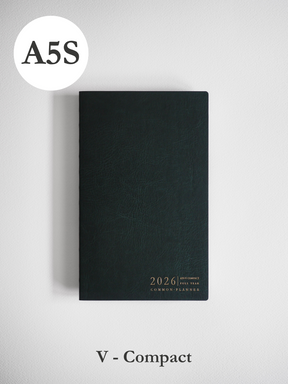 A minimalist, matte black vertical planner cover featuring elegant metallic typography centered at the bottom for the year 2026.