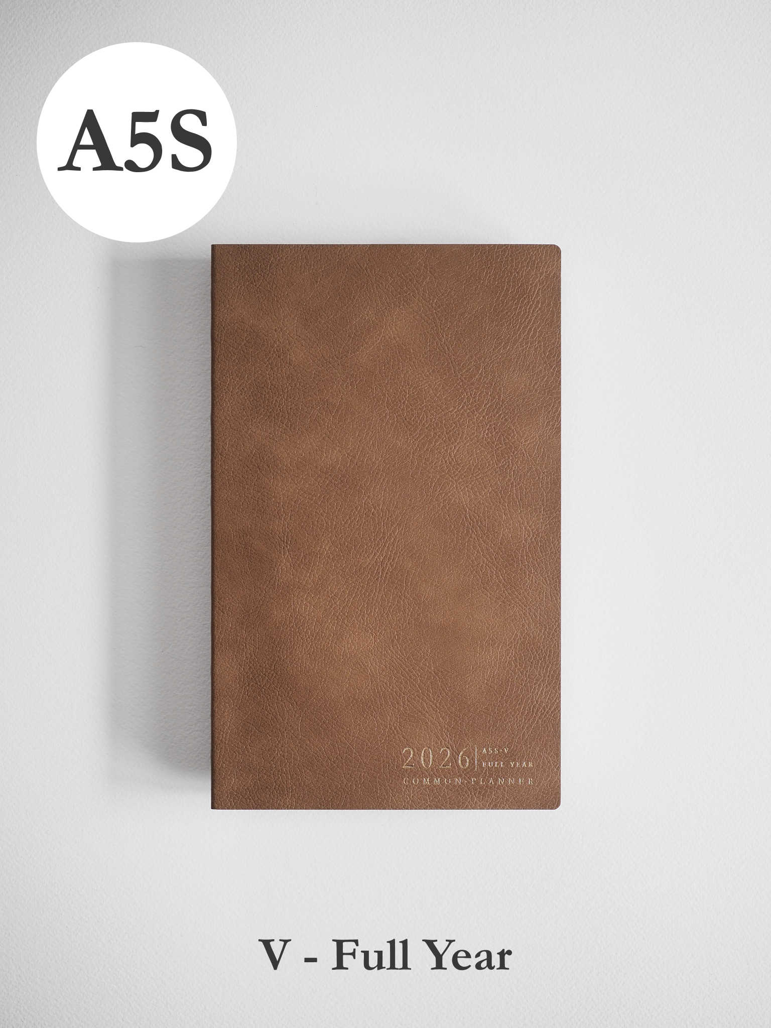 Minimalist A5 planner featuring a solid taupe faux leather cover embossed with "2026" and "COMMON PLANNER" text near the bottom.