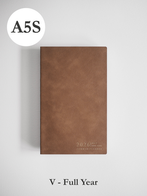 Minimalist A5 planner featuring a solid taupe faux leather cover embossed with "2026" and "COMMON PLANNER" text near the bottom.