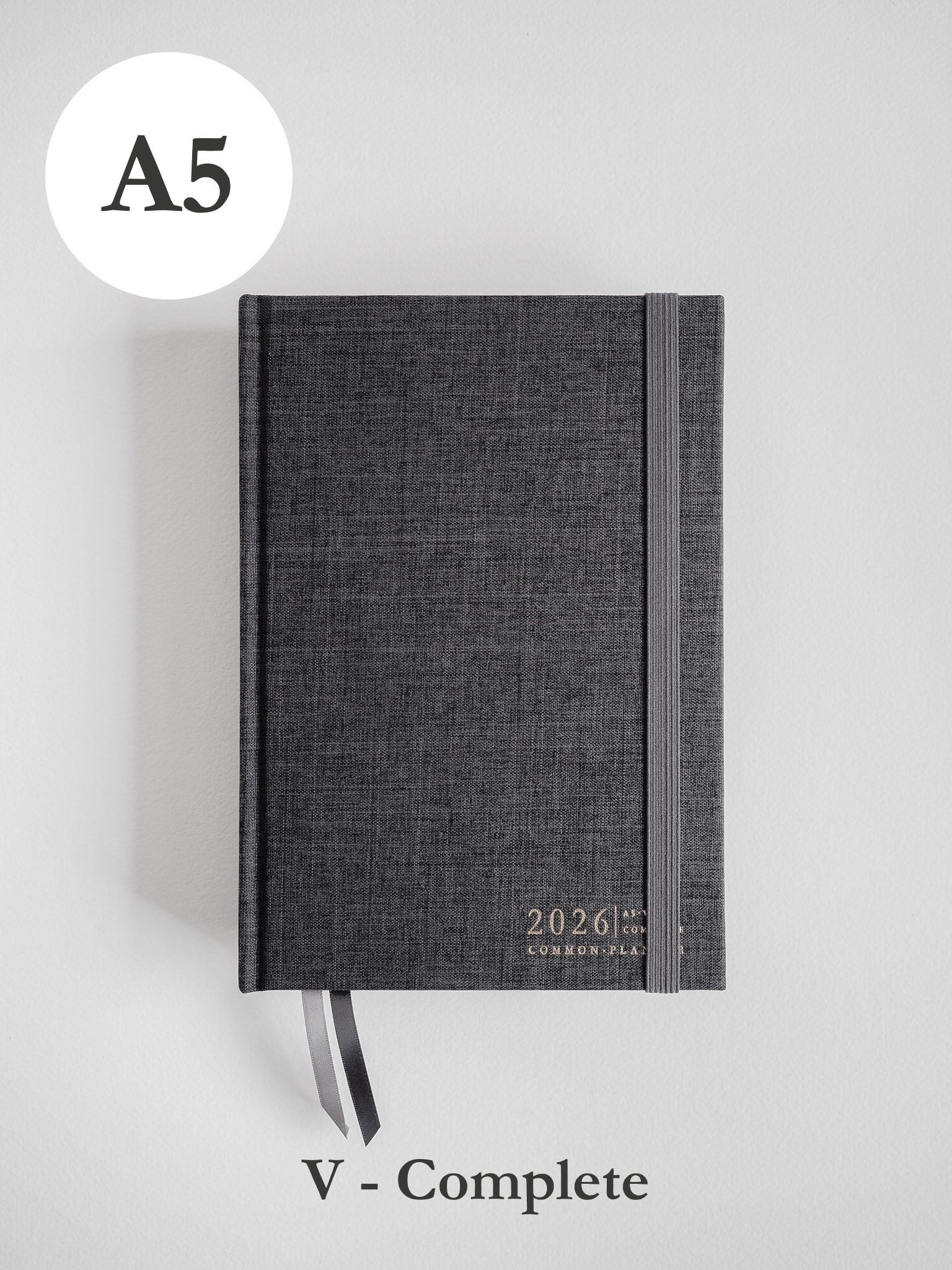 Dark gray A5 planner for 2026, featuring a textured, minimalist cover and common planner branding.