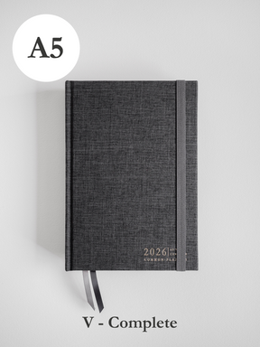 Dark gray A5 planner for 2026, featuring a textured, minimalist cover and common planner branding.