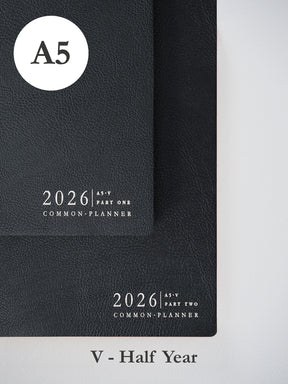 Two stacked black A5 vertical planners for 2026, featuring minimalist embossed white lettering to mark the "Common Planner" for both parts.