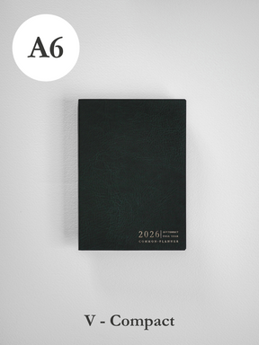 Sleek, dark A6 vertical planner featuring a textured black cover and elegant embossed text indicating the 2026 common planner year.