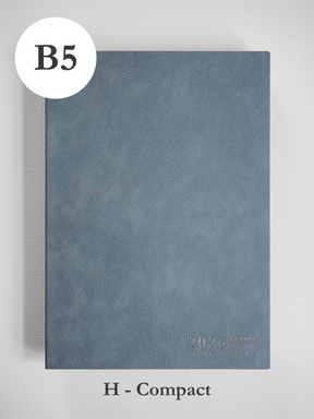 A minimalist B5 planner cover in slate gray features a matte, textured finish and subtle debossed text indicating the year 2026.
