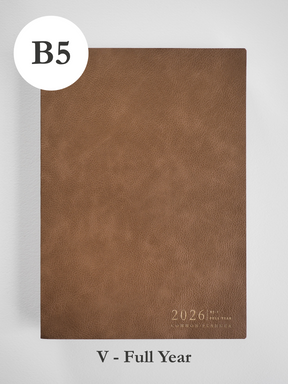 Tan B5 faux leather planner cover featuring embossed text that reads "2026 Common Planner," ready for a full year of scheduling.