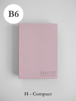 Soft blush pink B6 planner cover displaying minimalist black lettering for the 2026 Common Planner.