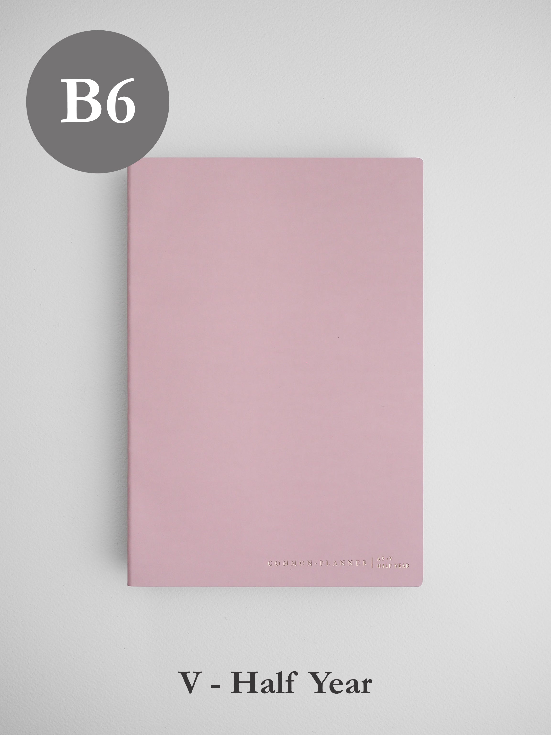 Minimalist blush pink B6 vertical planner cover for a half-year, featuring a solid, elegant design perfect for undated planning.