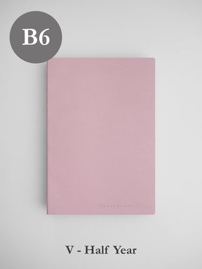 Minimalist blush pink B6 vertical planner cover for a half-year, featuring a solid, elegant design perfect for undated planning.