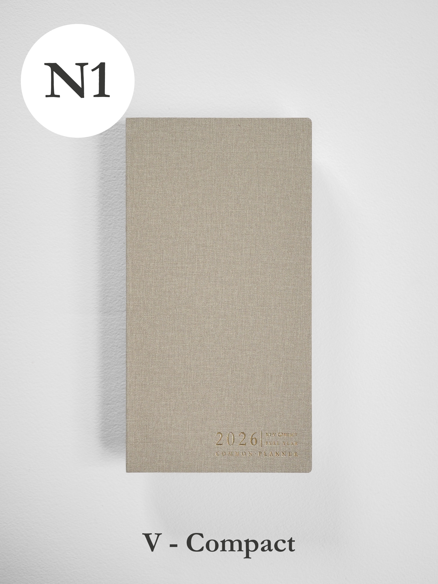 Compact, vertical planner featuring a light beige, kraft-colored cover subtly stamped with the year 2026 and "Common Planner."