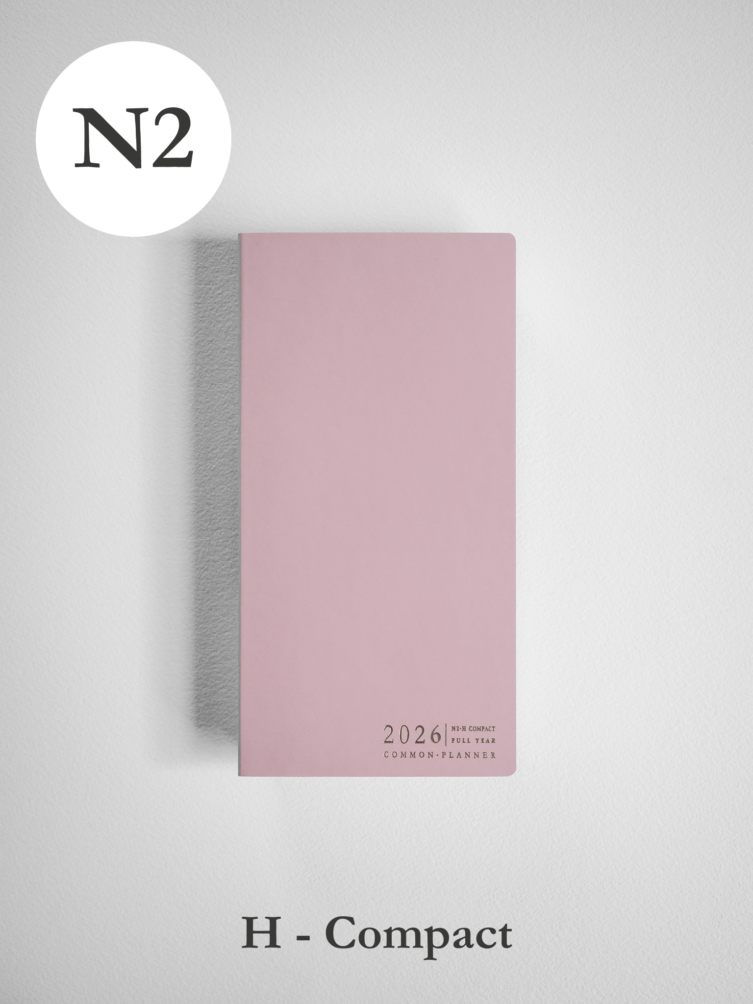 Blush pink horizontal compact planner for 2026, featuring common planner branding and a sophisticated, minimalist design.