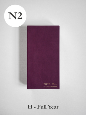 Rich deep burgundy planner cover displaying the embossed year "2026" and the phrase "Common Planner" in elegant gold lettering.