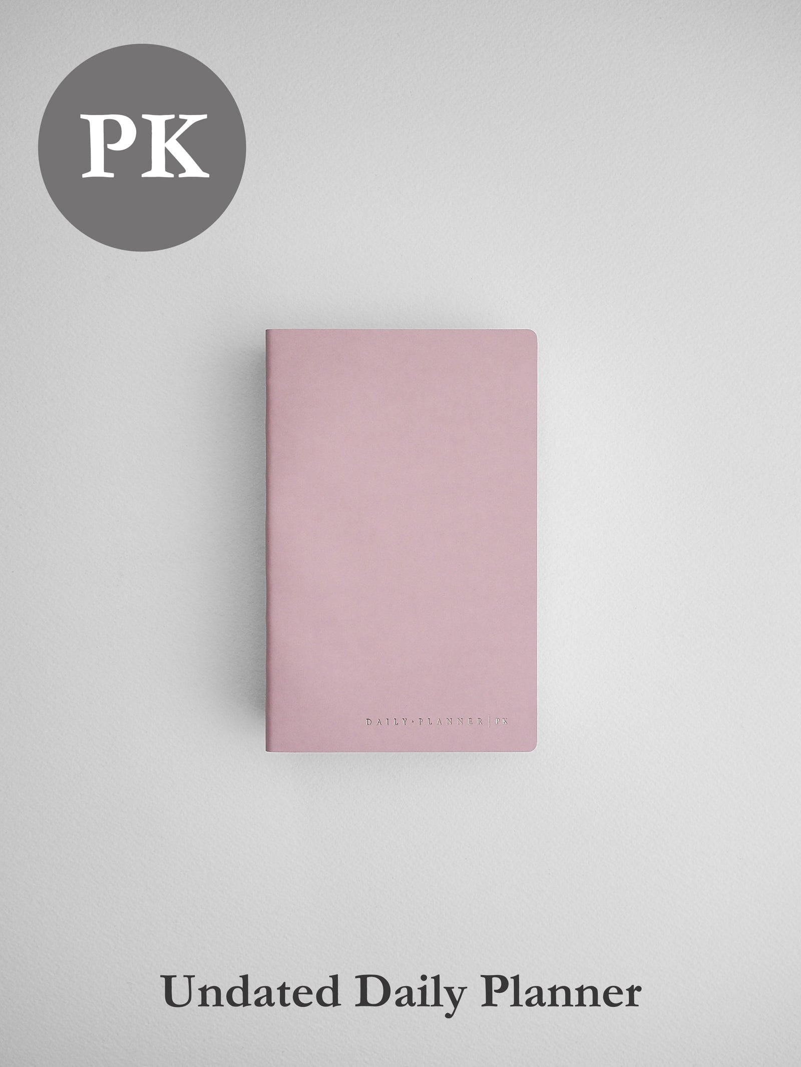 Soft blush pink undated daily planner notebook, featuring a simple, elegant, minimalist matte cover design.