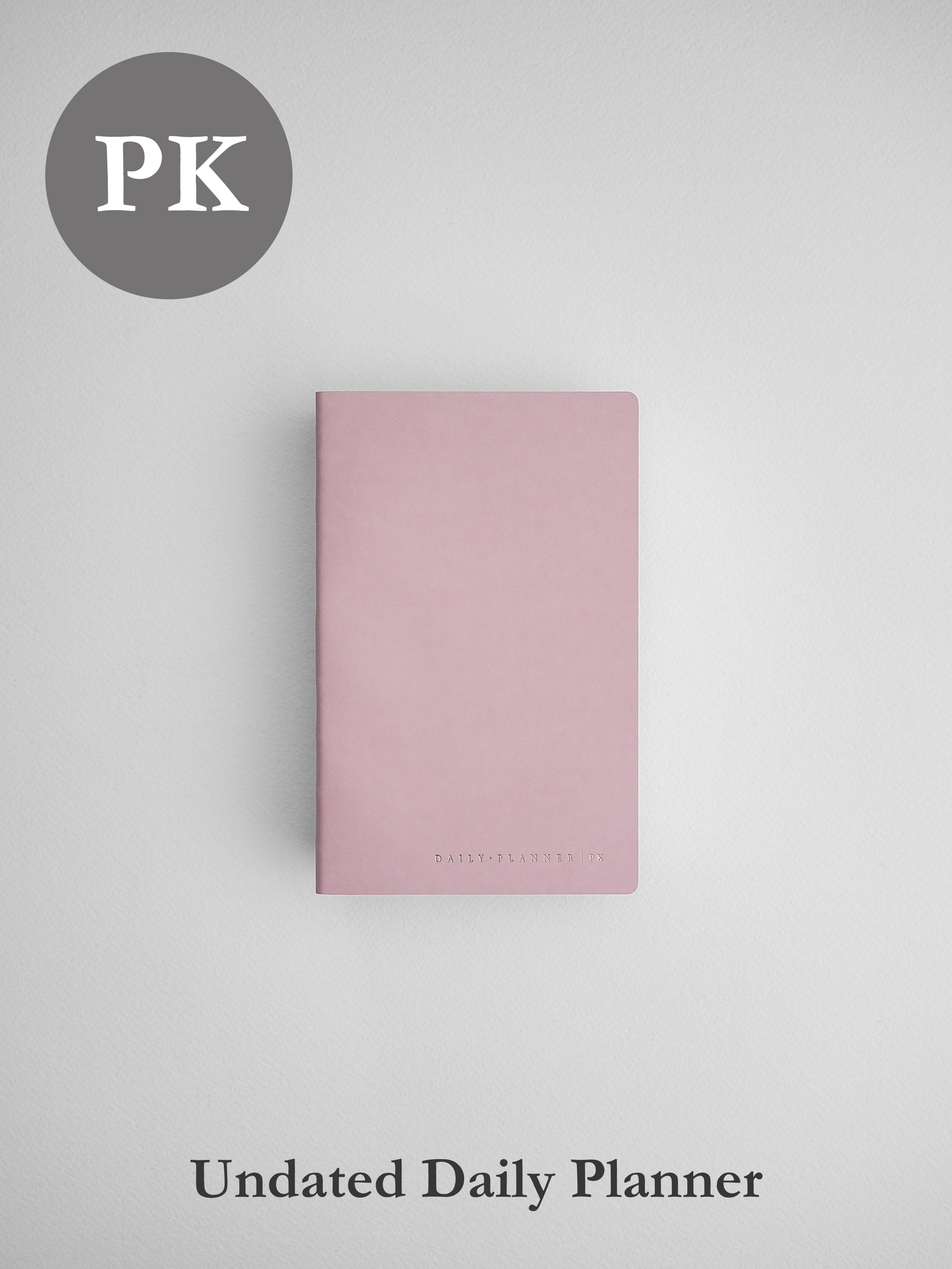 Soft blush pink undated daily planner notebook, featuring a simple, elegant, minimalist matte cover design.