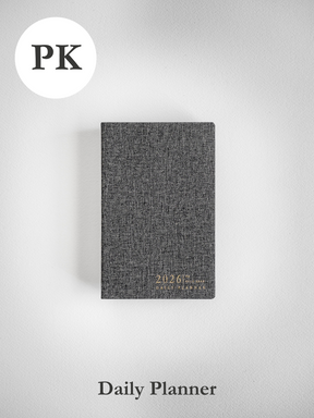 Compact, charcoal-grey daily planner featuring a textured cover and elegantly printed "2026" date and title for full-year planning.