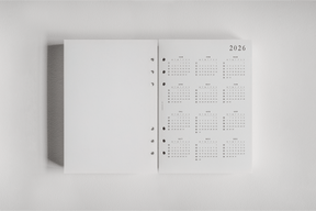 White dated planner inserts displaying organized monthly calendars for 2026, perfect for tracking daily schedules and year-at-a-glance academic or personal planning.