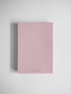 Pale pink A5 horizontal planner featuring the title "COMMON PLANNER" and "DESIGNED BY STERLING INK," perfect for yearly organization and journaling.