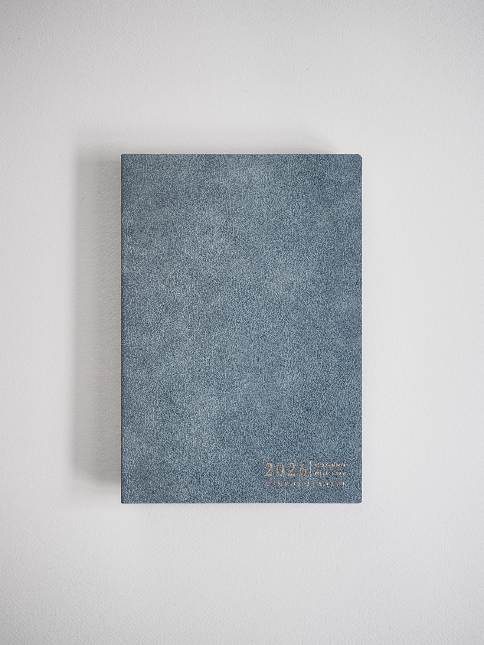 Textured slate gray A5 planner featuring a minimalist design with the year 2026 printed in delicate gold lettering.