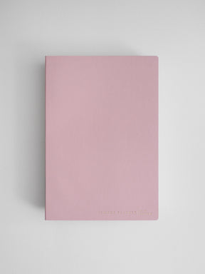 Minimalist pale pink common planner for full-year journaling and organization, featuring a clean, solid cover and simple typography.