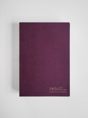 Elegant A5 horizontal planner bound in deep maroon faux leather, featuring minimal, centered gold-toned text for "2026 Common Planner."
