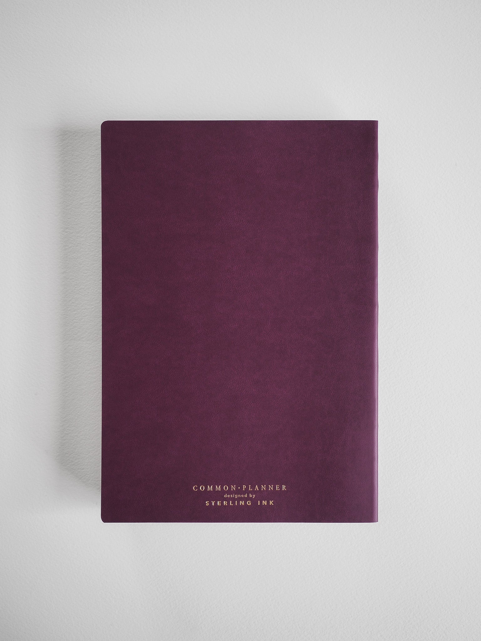 Matte burgundy A5 common planner for 2026, featuring minimalist debossed branding for "Common Planner" and "Syerling Ink."