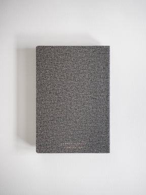 A structured A5 horizontal planner cover in heather grey, featuring a subtle branded design perfect for year-long 2026 planning.