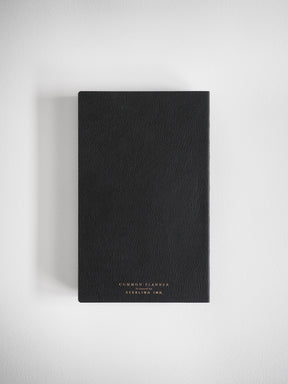 Sleek black A5 planner with a minimalist matte cover, debossed with the professional text "COMMON PLANNER designed by STERLING INK."