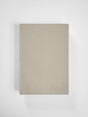 Minimalist A5 planner cover in light beige kraft paper featuring centered debossed text that reads "2026 Common Planner."
