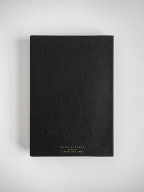 A sleek, black A5 daily planner featuring gold-embossed text that reads "DAILY PLANNER designed by STERLING INK."
