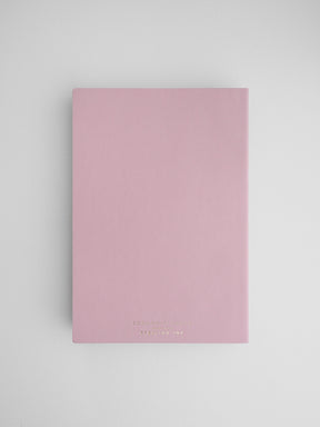 Minimalist pale blush pink A5 common planner notebook featuring simple centered branding for Stirling Ink.