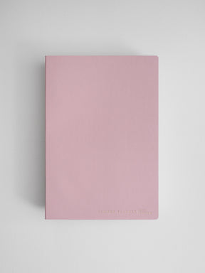 Minimalist dusty rose A5 vertical planner notebook featuring a solid pale pink cover and debossed text reading "Common Planner | Full Year."