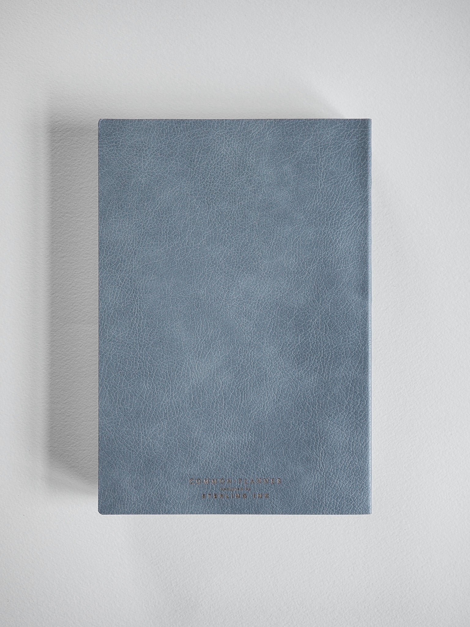 Minimalist A5 vertical planner with a solid slate grey matte cover, designed for the 2026 year.
