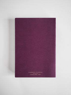 Deep plum, A5 vertical planner with a matte finish and minimalist white typography featuring the brand name "Common Planner" and "SYERLING INK."