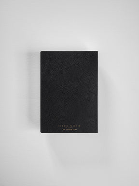 A black, A6 horizontal Common Planner featuring a textured faux leather cover and subtle gold-toned branding for the 2026 year.