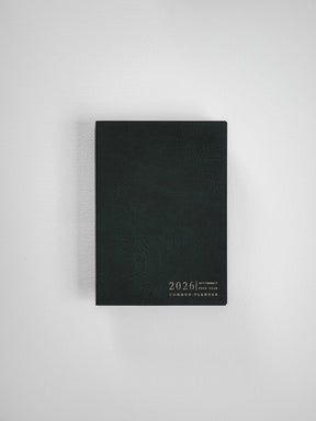 Sleek, black compact planner cover displaying minimalist embossed text that reads "2026 Compact Full Year Common Planner."