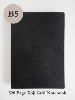 A black textured notebook cover shown flat against a light gray background, with a beige circle labeled 'B5' in the top left and text at the bottom reading '520 Page Koji Grid Notebook'.
#Color_Onyx