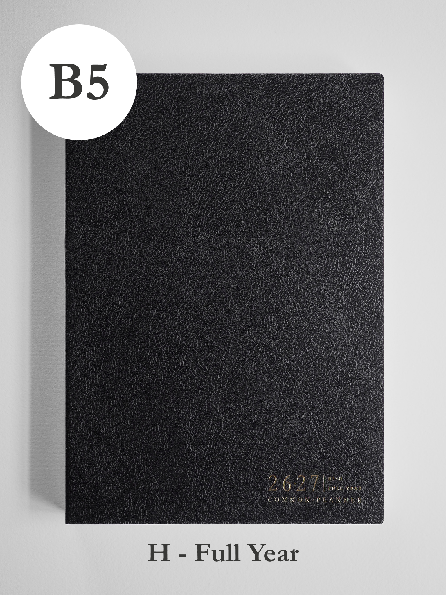 Matte black B5 academic planner featuring a faux-leather cover, designed horizontally and stamped with "2026-2027 Common Planner" for full-year use.