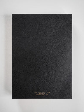 Black B5 common planner with a textured faux leather cover, featuring "Common Planner" text, designed for full-year planning.
