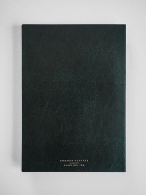 Deep, textured dark emerald green planner featuring centered white branding that reads "COMMON PLANNER designed by STERLING INK."
