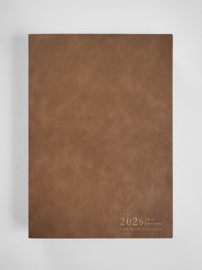 Deep brown faux leather planner cover displaying "2026" and "Common Planner" text in a clean, vertical format.